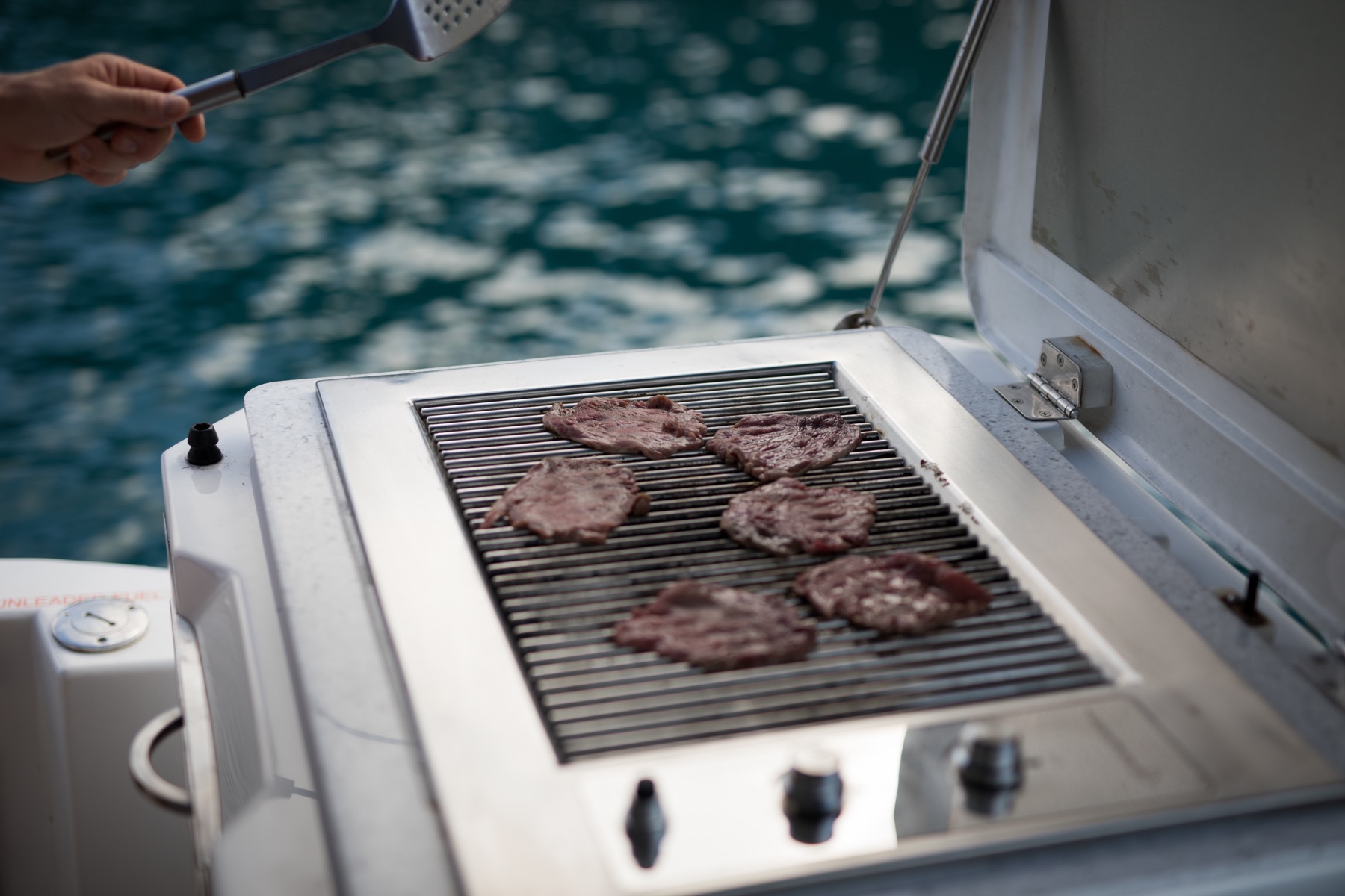 Barbecue cooking on a boat, illustrative stock photograph