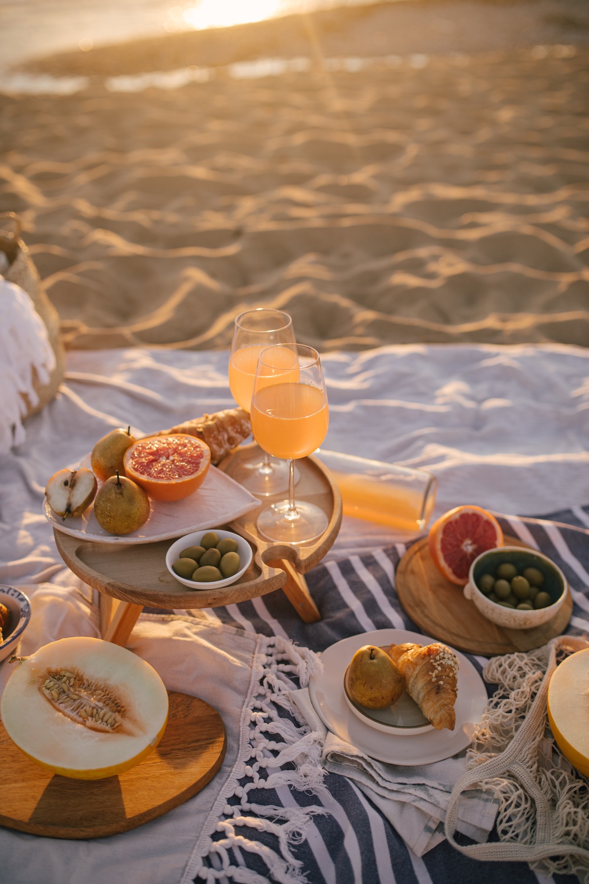 Fruit and juice laid out for a beach picnic, illustrative stock photograph
