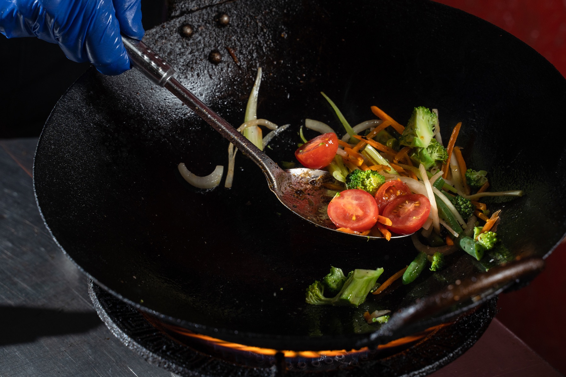 Vegetables being cooked in a wok, illustrative close-up