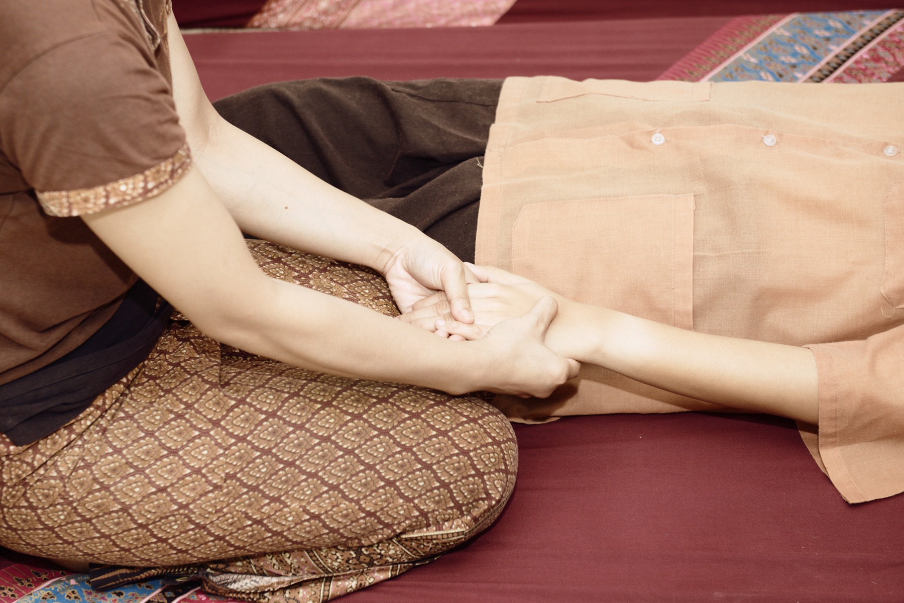 Hands receiving a massage, illustrative stock detail