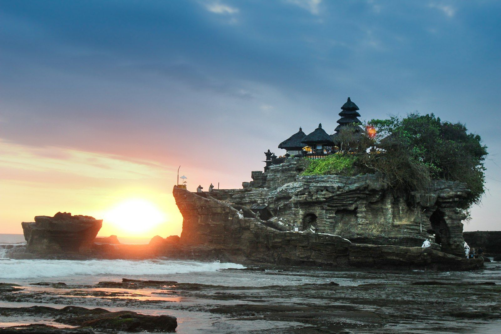 A sea temple on the rocks at sunset
